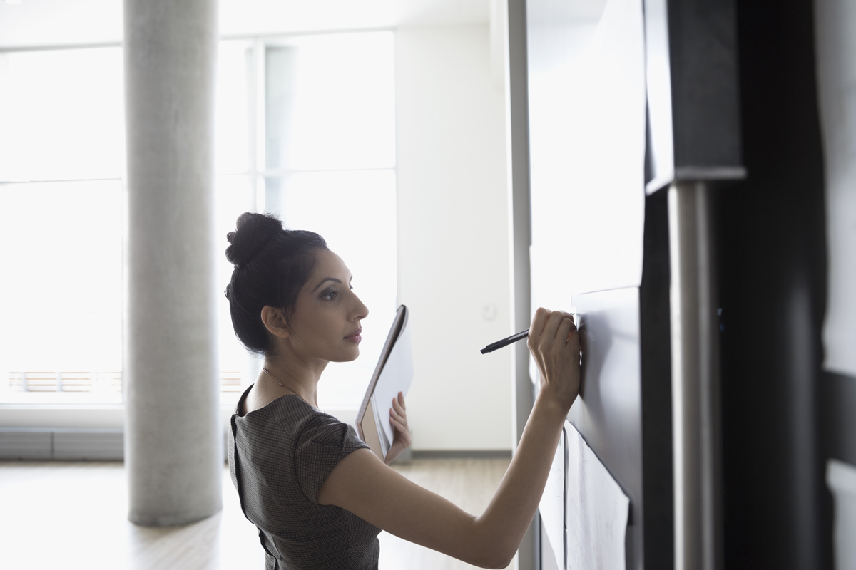 Businesswoman brainstorming, preparing for meeting